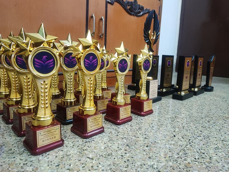 Custom branded trophy awards lined up for a college programme