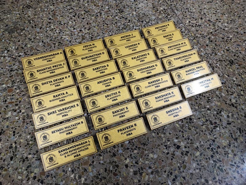 Engraved brass name plates for college department members