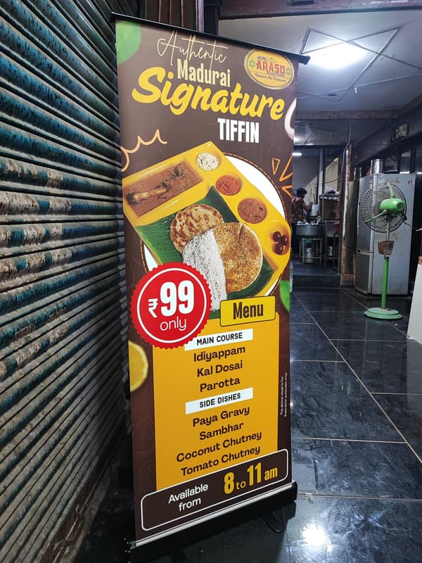Madurai Signature Tiffin roll-up standee outside a restaurant
