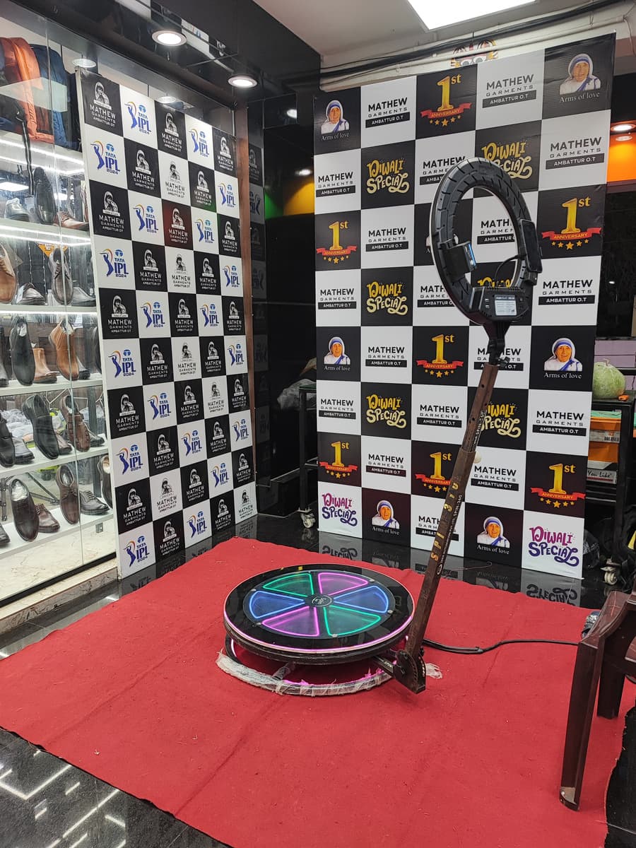 Mathew Garments event booth with branded backdrop and 360 photo booth