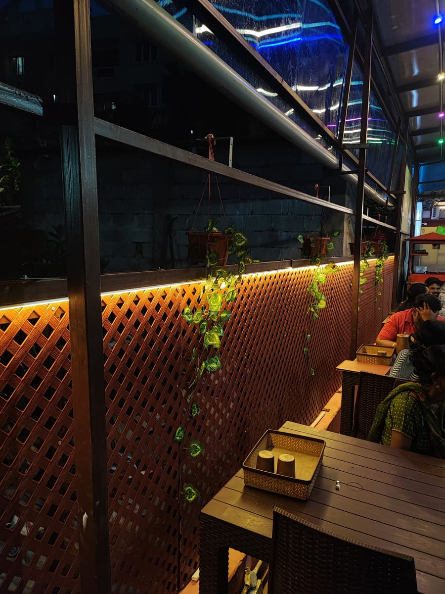Café interior with wood lattice partition and warm LED lighting