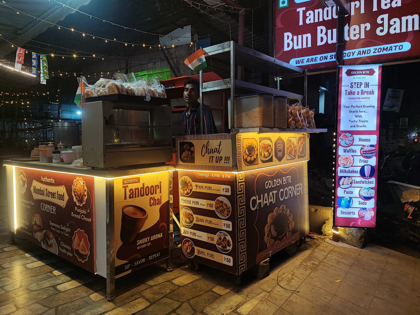Tandoori Tea, Bun Butter Jam and Chaat Corner branded stalls at night